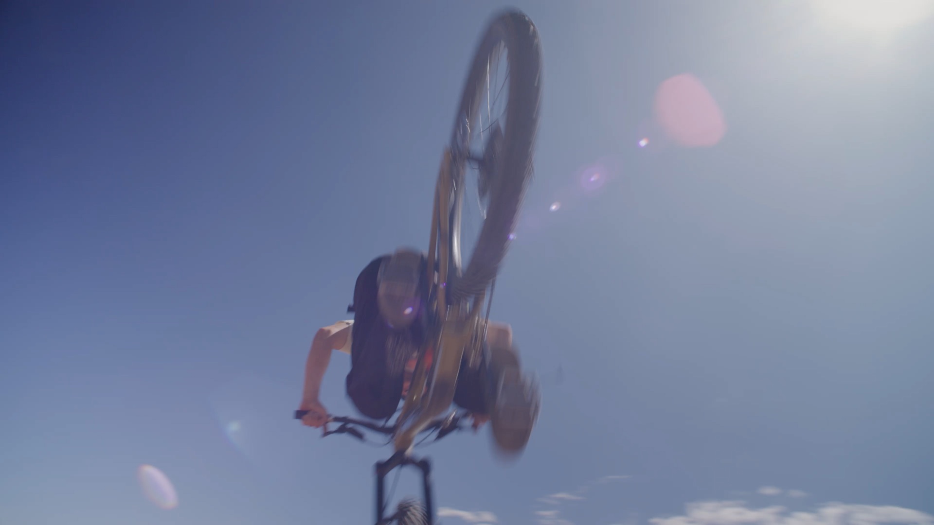 Rider mid-backflip against open sky — still from the Trash Pit edit